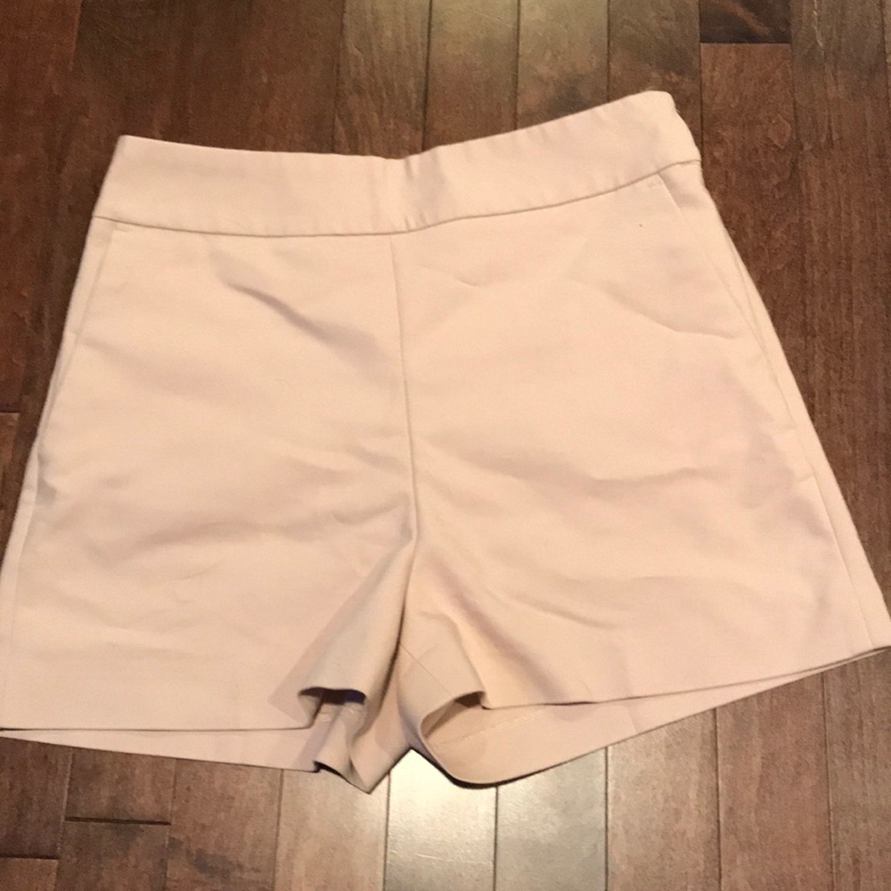 Express light pink shorts with an extra button.